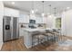 Bright and airy kitchen with a large center island, stainless steel appliances, and modern pendant lighting at 1402 Richmond Dr # 1, Lowell, NC 28098