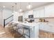 Open-concept kitchen featuring an island with seating, sleek appliances, and hardwood flooring at 1402 Richmond Dr # 1, Lowell, NC 28098