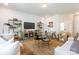 Comfortable living room features stylish decor, large TV, and elegant gold shelving for a relaxing atmosphere at 1402 Richmond Dr # 1, Lowell, NC 28098