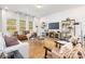 Bright living room with large windows, a cozy leather sofa, and views of the green surroundings at 1402 Richmond Dr # 1, Lowell, NC 28098