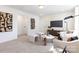 Comfortable upstairs living area features neutral carpet, a TV and a gold accent wall at 1402 Richmond Dr # 1, Lowell, NC 28098
