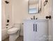 Stylish bathroom featuring modern fixtures, a vanity with storage, and tile flooring at 1522 Wickham Ln, Charlotte, NC 28208