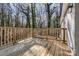 New wood deck with railings, perfect for outdoor relaxation with a view of the surrounding trees and greenery at 1522 Wickham Ln, Charlotte, NC 28208