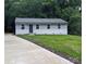Charming single-story home features a well-manicured lawn and a paved driveway for easy parking at 1522 Wickham Ln, Charlotte, NC 28208