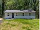 Charming single-story home with freshly painted exterior and a well-manicured lawn at 1522 Wickham Ln, Charlotte, NC 28208