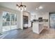 Bright kitchen with white cabinets, stainless steel appliances, and sliding doors to a deck at 1522 Wickham Ln, Charlotte, NC 28208