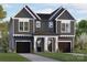 Charming two-story townhome with a modern gray and white exterior and well-manicured front lawn at 2526 Elkwood Cir, Charlotte, NC 28205