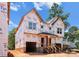New two-story home with unfinished siding shows large front-facing windows and dual covered entries at 2526 Elkwood Cir, Charlotte, NC 28205