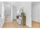 Bright entryway with wood floors, console table, decorative mirror and staircase at 3812 Odom Way, Charlotte, NC 28216
