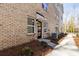 Inviting townhome exterior showcasing a brick facade, black door, and well-maintained landscaping at 3812 Odom Way, Charlotte, NC 28216
