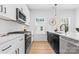 Stylish kitchen boasting stainless steel appliances, black hardware, and bright white countertops at 3812 Odom Way, Charlotte, NC 28216
