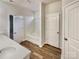 Bright bathroom with a large soaking tub, wood look floors, and white vanity at 508 Stone River Pkwy, Mount Holly, NC 28120