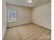 Minimalist bedroom with neutral carpeting and a window for natural light at 508 Stone River Pkwy, Mount Holly, NC 28120