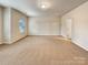 Spacious bonus room with neutral carpet and a bright window at 508 Stone River Pkwy, Mount Holly, NC 28120