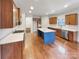 Open kitchen featuring an island, stainless steel appliances, and wood cabinetry at 508 Stone River Pkwy, Mount Holly, NC 28120