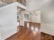 Bright living room featuring hardwood floors, high ceilings, and open layout at 508 Stone River Pkwy, Mount Holly, NC 28120