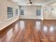 Spacious living room with hardwood floors and abundant natural light from multiple windows at 508 Stone River Pkwy, Mount Holly, NC 28120
