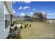 Expansive backyard with a covered patio, privacy fence, and scattered small trees at 5239 Admirals Lndg, Lancaster, SC 29720