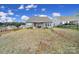 Backyard with a covered patio and a gentle slope, perfect for outdoor relaxation and activities at 5239 Admirals Lndg, Lancaster, SC 29720