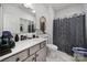 Clean bathroom featuring a single sink vanity and a toilet with patterned shower curtain at 5239 Admirals Lndg, Lancaster, SC 29720