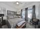 Serene bedroom with neutral tones, patterned bedding, and a cozy bench at 5239 Admirals Lndg, Lancaster, SC 29720
