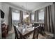 Cozy dining room with a wooden table, floral arrangements, and natural light from multiple windows at 5239 Admirals Lndg, Lancaster, SC 29720