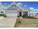 Charming single-Gathering home with a two-car garage, stone accents, and a well-manicured lawn at 5239 Admirals Lndg, Lancaster, SC 29720
