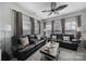Comfortable living room featuring plush leather sofas, a ceiling fan, and ample natural light at 5239 Admirals Lndg, Lancaster, SC 29720