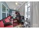 Relaxing porch with red cushioned wicker seating, ceiling fans, and sheer curtains at 5239 Admirals Lndg, Lancaster, SC 29720