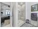 Bright bathroom featuring a glass-enclosed shower and linen closet, and a glimpse into the bedroom at 5239 Admirals Lndg, Lancaster, SC 29720