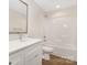 Clean bathroom featuring a single sink, shower-tub combo, and white cabinets at 8465 Old Plank Rd, Charlotte, NC 28216