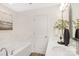 Bathroom featuring double sinks, large tub, and a marble backsplash at 8465 Old Plank Rd, Charlotte, NC 28216