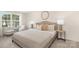 Comfortable bedroom featuring neutral tones, a decorative mirror, and plush bedding at 8465 Old Plank Rd, Charlotte, NC 28216