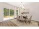Cozy dining room with a sliding glass door to the backyard, modern decor, and a stylish chandelier at 8465 Old Plank Rd, Charlotte, NC 28216