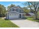 Charming two-story home featuring a two-car garage, gray siding, and a well-maintained lawn at 8465 Old Plank Rd, Charlotte, NC 28216