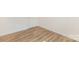 Room featuring wood grain flooring, and white base molding against white walls at 8465 Old Plank Rd, Charlotte, NC 28216