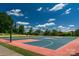Outdoor basketball court with vibrant colors, surrounded by lush greenery, ready for a game at 9900 Silverling Dr, Waxhaw, NC 28173