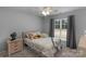 Bedroom featuring a plush bed, a window with curtains, and natural light at 9900 Silverling Dr, Waxhaw, NC 28173