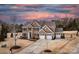 Stunning two-story brick home showcasing a well-manicured lawn and three-car garage at 9900 Silverling Dr, Waxhaw, NC 28173
