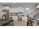Kitchen with built-in desk, stainless steel refrigerator, and views of the dining area at 9900 Silverling Dr, Waxhaw, NC 28173