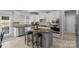Well-lit kitchen features white cabinetry, granite countertops, stainless steel appliances and a large center island with seating at 9900 Silverling Dr, Waxhaw, NC 28173