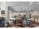 Cozy living room connected to the kitchen, showcasing a leather sofa and an open layout at 9900 Silverling Dr, Waxhaw, NC 28173