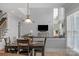 Open concept living room with two-story ceilings, a large picture window, and dining area at 9900 Silverling Dr, Waxhaw, NC 28173