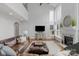 Bright and airy living room featuring two-story windows, a fireplace, and hardwood floors at 9900 Silverling Dr, Waxhaw, NC 28173