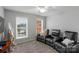 The sitting room includes comfortable chairs, and windows to the outdoor view at 9900 Silverling Dr, Waxhaw, NC 28173