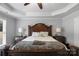 Elegant main bedroom with tray ceiling, a large bed, and natural light at 9900 Silverling Dr, Waxhaw, NC 28173