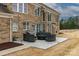 Brick home's backyard patio features outdoor seating, a grill, and ample space for entertaining at 9900 Silverling Dr, Waxhaw, NC 28173