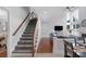 View of the staircase leading up to the second floor, adjacent to a comfortable living area at 9900 Silverling Dr, Waxhaw, NC 28173