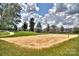 Sand volleyball court is ready for a game, with a net and grassy surroundings at 9900 Silverling Dr, Waxhaw, NC 28173
