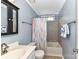 The bathroom has blue walls, a tub and shower with a blue and red curtain at 10213 Conistan Pl, Cornelius, NC 28031